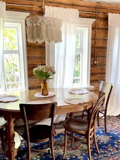 Traditional Russian dacha interior with wooden walls, vintage furniture, and a cozy dining room